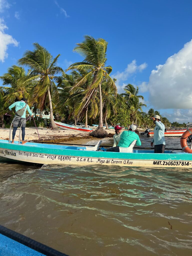 Fly fishermen docking their panga on the beach.