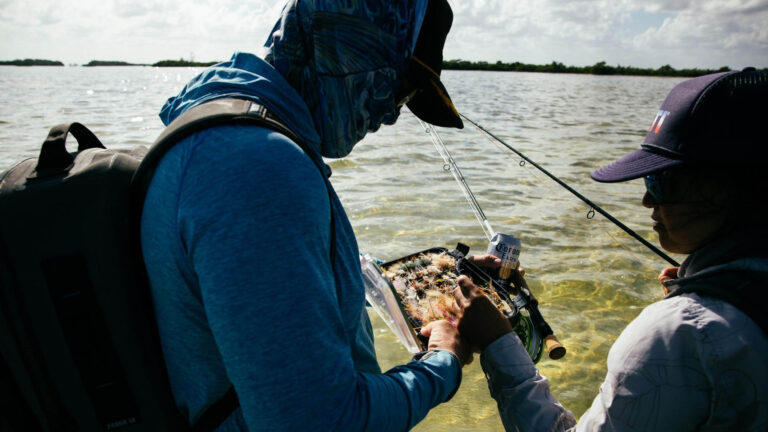 Fly fishermen choosing their fly on Ascension Bay, Mexico.
