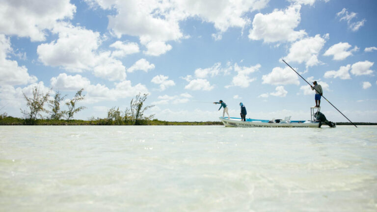 Fly fishermen in a panga on the flats of Ascension Bay, Mexico.