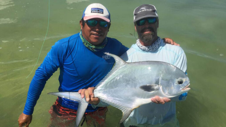 An inshore fly fishermen catches a permit in Ascension Bay, Mexico.
