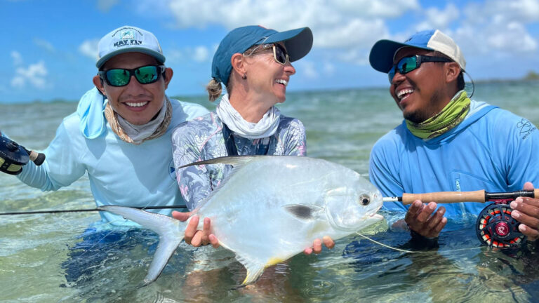 A guest of Kay Fly fishing catches a permit in shore fly fishing.