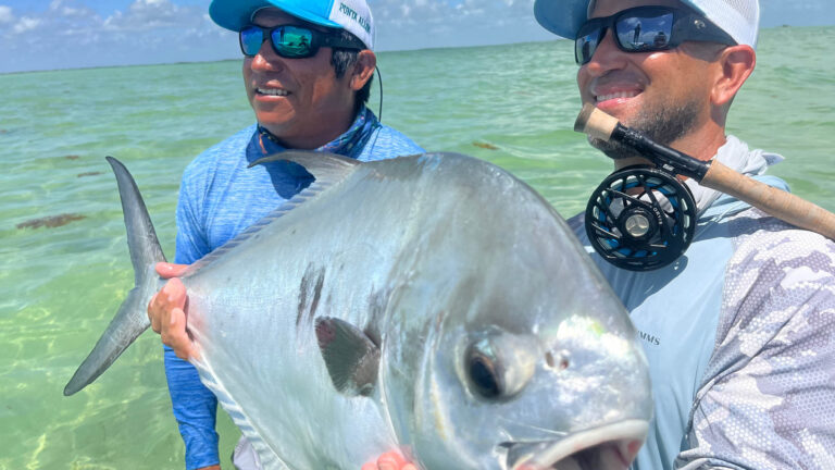 A guest of Kay Fly fishing catches a permit inshore fly fishing.