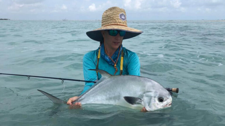 An inshore fly fishermen catches a permit in Ascension Bay, Mexico.